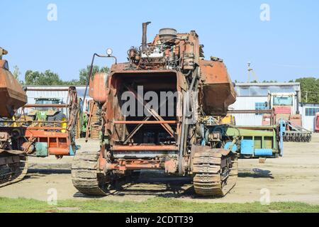 Old rusty disassembled combine harvester. Stock Photo