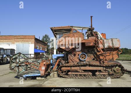 Old rusty disassembled combine harvester. Stock Photo