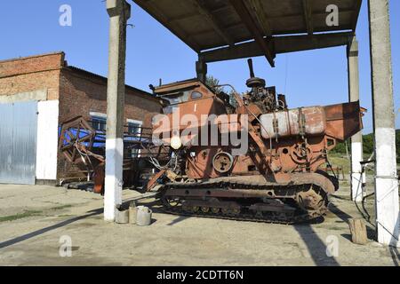 Old rusty disassembled combine harvester. Stock Photo