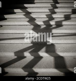 Shadow of a window grille on the steps of a staircase Stock Photo