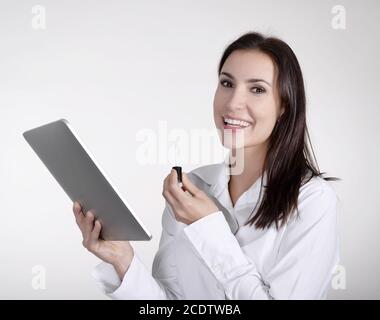 businesswoman with lipstick using digital tablet Stock Photo