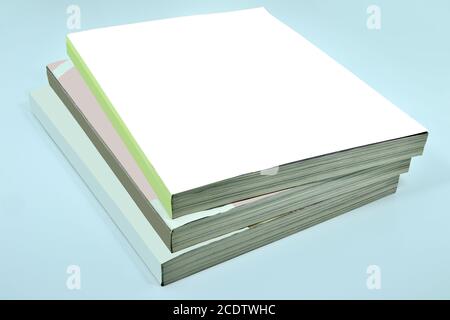 Stack of three thick magazines or books, catalogs with blank white cover Stock Photo