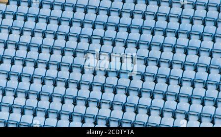 Rows of blue plastic stadium seats. Stock Photo