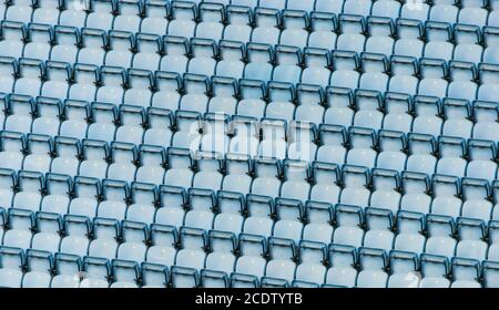 Rows of blue plastic stadium seats. Stock Photo