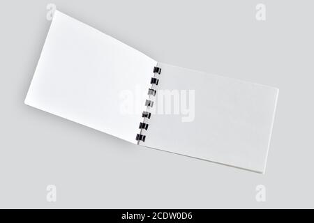 Blank open notebook or brochure close up, isolated on light gray Stock Photo