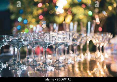 Closeup of martini glasses with alcoholic drinks on bar in night club with colorful bokeh background. Close up alcohol in pub restaurant. Food and bev Stock Photo