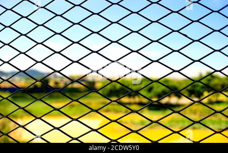 A silhouette of Metallic wired Fence seamless pattern with nature in back ground Stock Photo