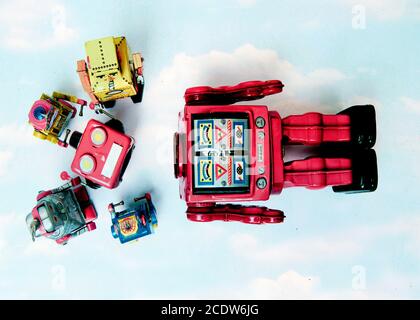 concept technical support;  woth a team of vintage robots fixing the big robots  head Stock Photo