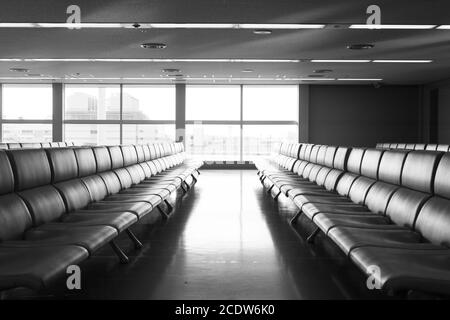 Bench in the terminal of airport , waiting area with chairs Stock Photo