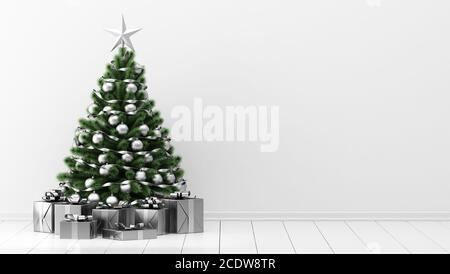 decorated christmas tree with gift boxes in white room Stock Photo