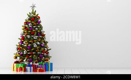 decorated christmas tree with gift boxes in white room Stock Photo