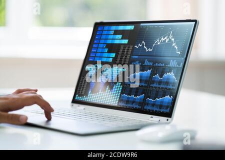 KPI Analytics And Stock Exchange Graphs On Laptop Stock Photo