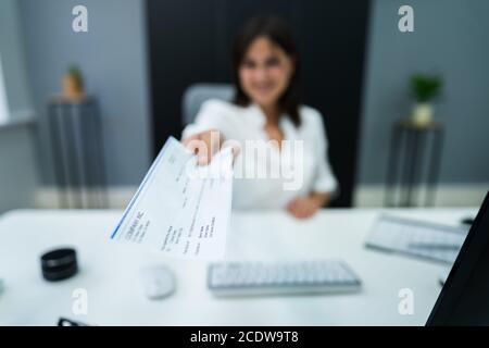 Employee Payroll Cheque. Handing Or Giving Salary Check Stock Photo