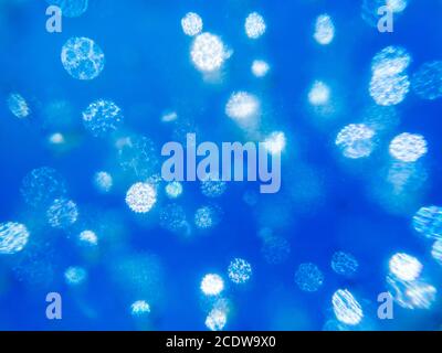 Light patterns created by bubbles inside of blue glass Stock Photo