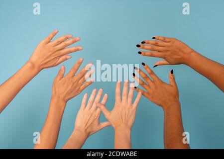 Three pairs of female hands of various ethnicities with different color of skin Stock Photo