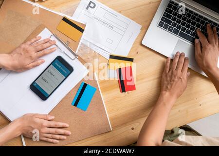 View of young female managers hands over workplace during checking information Stock Photo