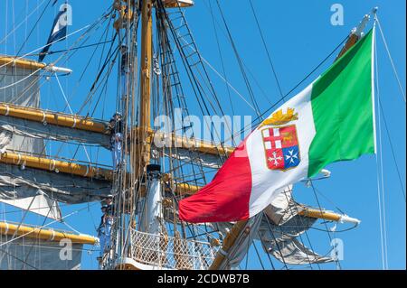 Italian Navy flag waving on the training ship of the Italian Navy 'AMERIGO VESPUCCI' in the harbour of Taranto, Italy Stock Photo