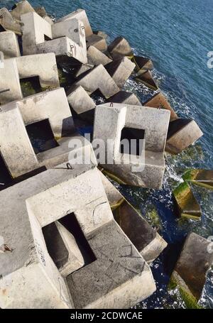 Breakwater of the rectangular stone figures. Stock Photo