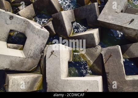 Breakwater of the rectangular stone figures. Stock Photo