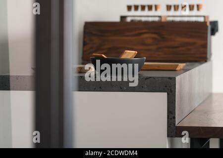 Modern minimalistic kitchen interior with concrete terrazzo countertop, shallow focus Stock Photo