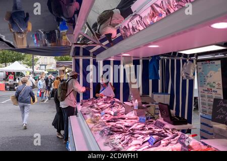 Angers, France - August 29 2020: people wearing face protective mask while shopping in the market place at France to prevent coronavirus, concept of wearing masks outdoor is mandatory Stock Photo