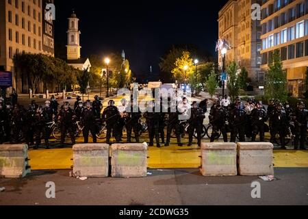 Police officers wearing full body armor hold a line in Black Lives Matter Plaza near the White House in Washington, DC, on August 29, 2020 amid the Coronavirus pandemic. At the end of a week of protests that kicked off after the police shooting of Jacob Blake in Wisconsin, then continued through the Republican National Convention, and culminated in The Commitment March: Get Your Knee Off Our Necks on Friday, Saturday brought emotional protest marches that ended with a violent police crackdown in Black Lives Matter Plaza late in the night. (Graeme Sloan/Sipa USA) Stock Photo