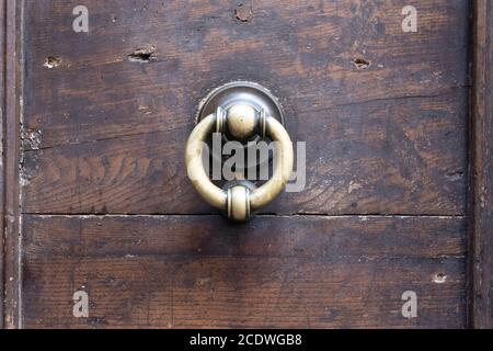 Metal knobs with decorative elements on a wooden door Stock Photo