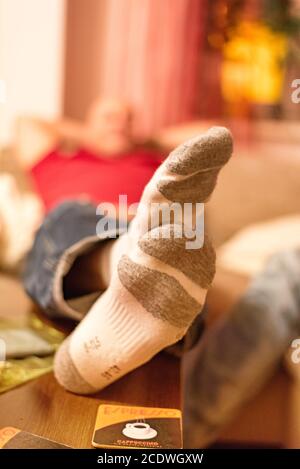 Feet on the table and wearing white sports socks Stock Photo