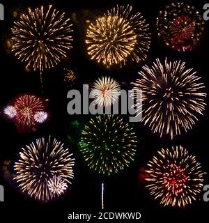 Colorful set of nine exploding fireworks, isolated on black background Stock Photo