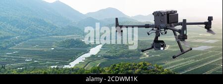 Agricultural drone flies over the field. Smart farming and digital transformation in agriculture. Stock Photo