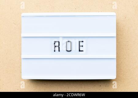 White lightbox with word ROE (Abbreviation of Return on equity) on wood background Stock Photo