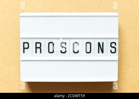 Lightbox with word  pros cons on wood background Stock Photo