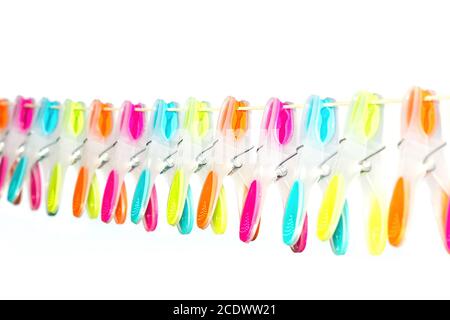 row of colorful clothespins hang on clothesline Stock Photo
