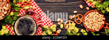 Light and dark german beer in big mugs and bowls with salty snacks and nuts, autumn beer festival concept. Panoramic banner with copy space Stock Photo