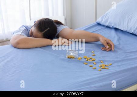 Female patients in the hospital overdose unconscious beside the bed. Stock Photo