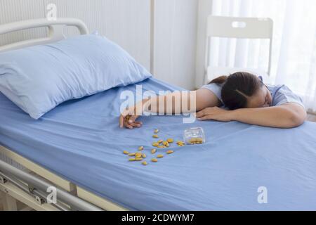 Female patients in the hospital overdose unconscious beside the bed Stock Photo