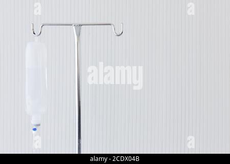 Saline solution iv bag with syringe line hanging on wall Stock Photo by  ©Mumemories 254338814