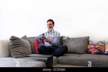 Smiling man typing on smartphone Stock Photo