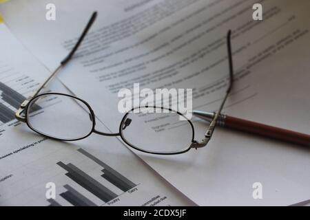 Business legal document concept : Pen and glasses on a agreement form Stock Photo
