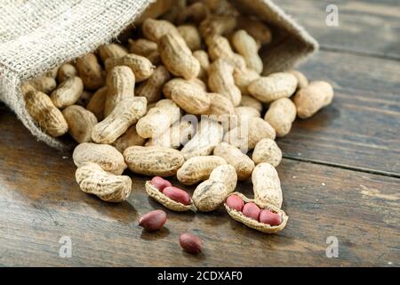 Peanuts in shells on a wooden table. Stock Photo