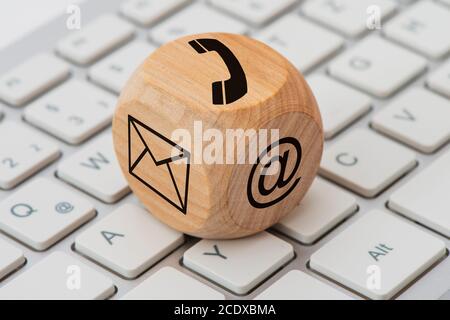 Contact for support printed on wooden cube on computer keyboard Stock Photo