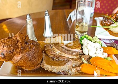 Sunday Roast with Yorkshire Pudding and Vegetables Stock Photo