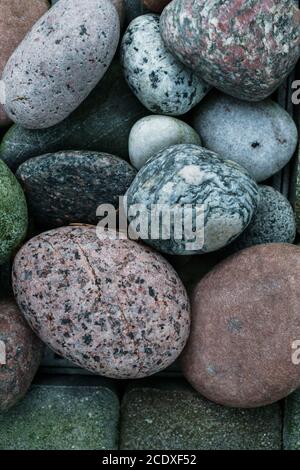 Abstract background with dry round granite stones. Stock Photo