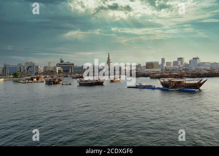 Doha corniche in Doha Qatar sunset shot taken from Arabic gulf with dhows (old wooden boats) with Qatar flag in water and Doha skyline in background Stock Photo