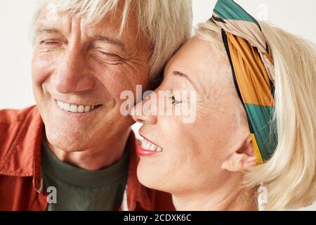 Close-up of mature couple enjoying each other isolated on white background Stock Photo