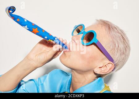 Close-up of mature woman in sunglasses having fun at party isolated on white background Stock Photo
