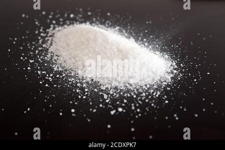 Salt on black Stock Photo
