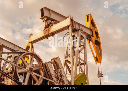 Oil pump rig. Oil and gas production. Oilfield site. Pump Jack are running. Drilling derricks for fossil fuels output and crude Stock Photo