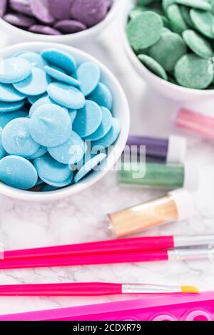 Flat lay. Ingredients to make chocolate mermaid molds from the chocolate chips. Stock Photo