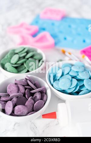 Flat lay. Ingredients to make chocolate mermaid molds from the chocolate chips. Stock Photo